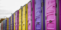 Valencia, Spain - November 29, 2019: Row of portable chemical toilets of various colors placed for an event on the streets of the city.