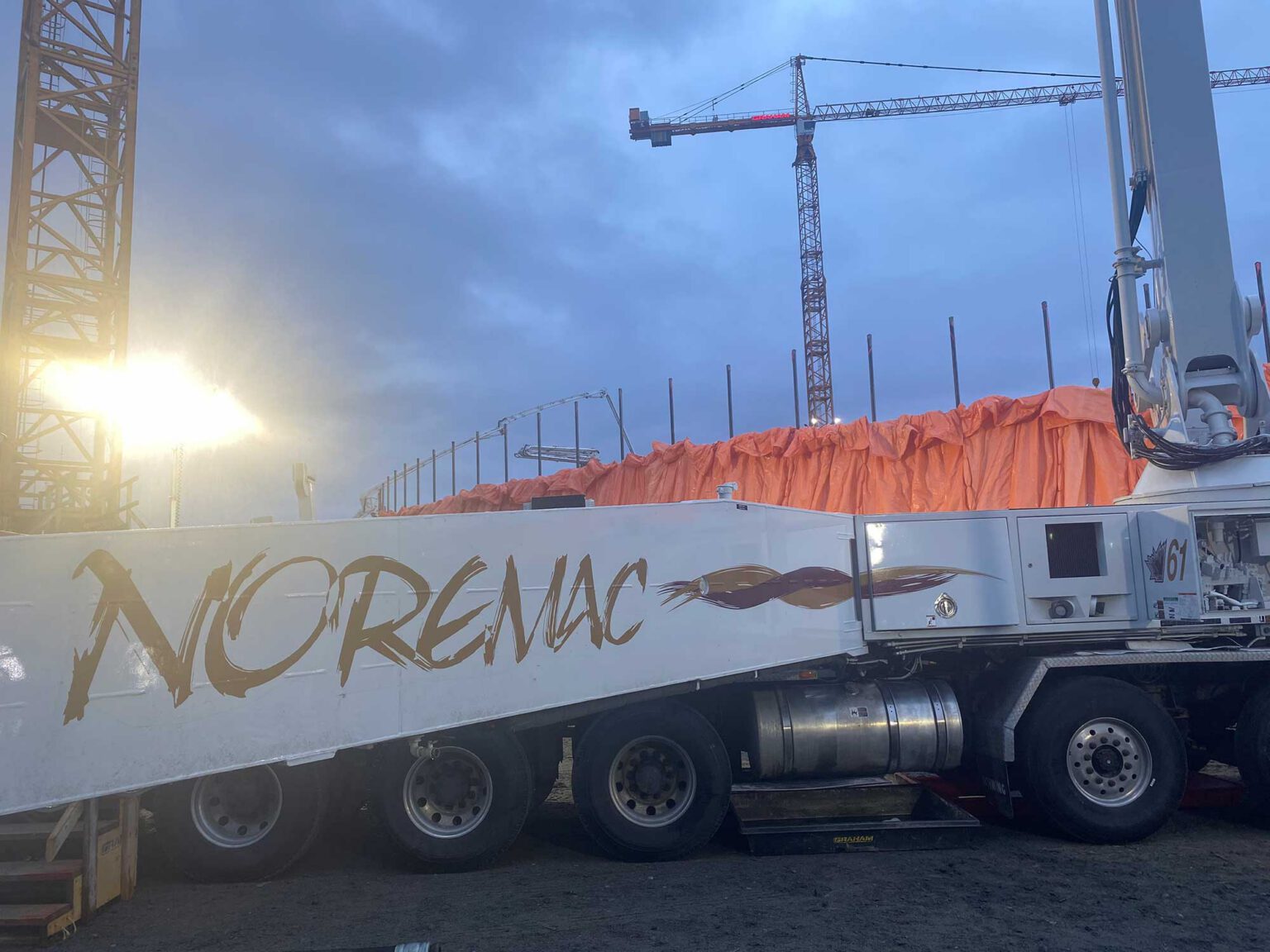 Industrial concrete with a Noremac truck in the foreground.