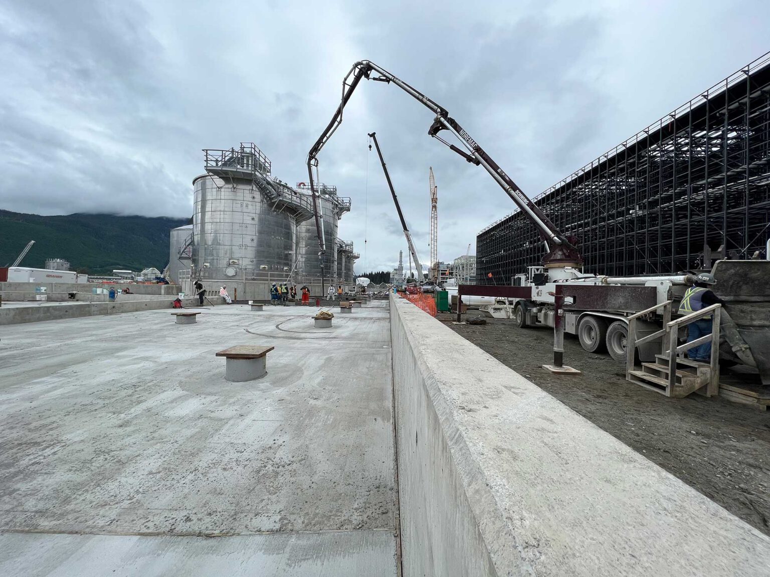 Noremac industrial concrete pumping in action. A spider boom in the mid-ground.