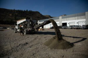 A Noremac stone slinger in action on an industrial job site.