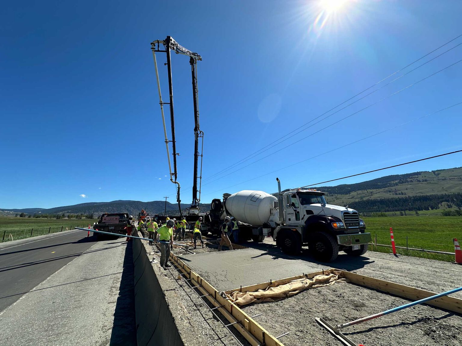 Concrete mixing in action, a spider boom in the midground.