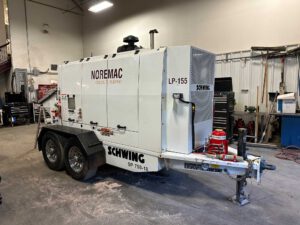 A Noremac branded Swing 750 line pump in a storage shop.