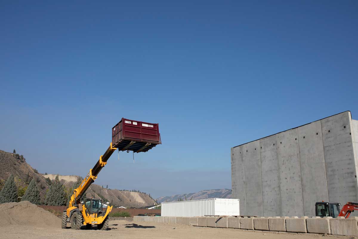 A Noremac branded zoom boom in action, blue sky in the background.