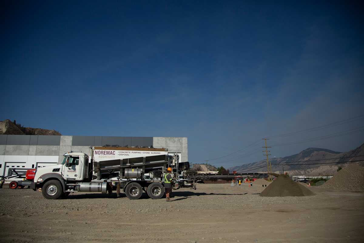 A Noremac stone slinger in action on a commercial job site.