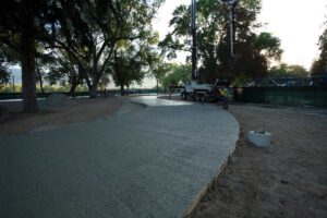 Noremac concrete workers in action, the sun setting in the background.