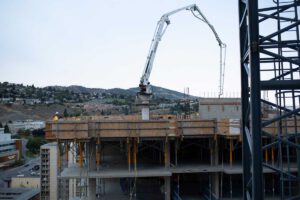 A Noremac boom pump on a multi-story job site.