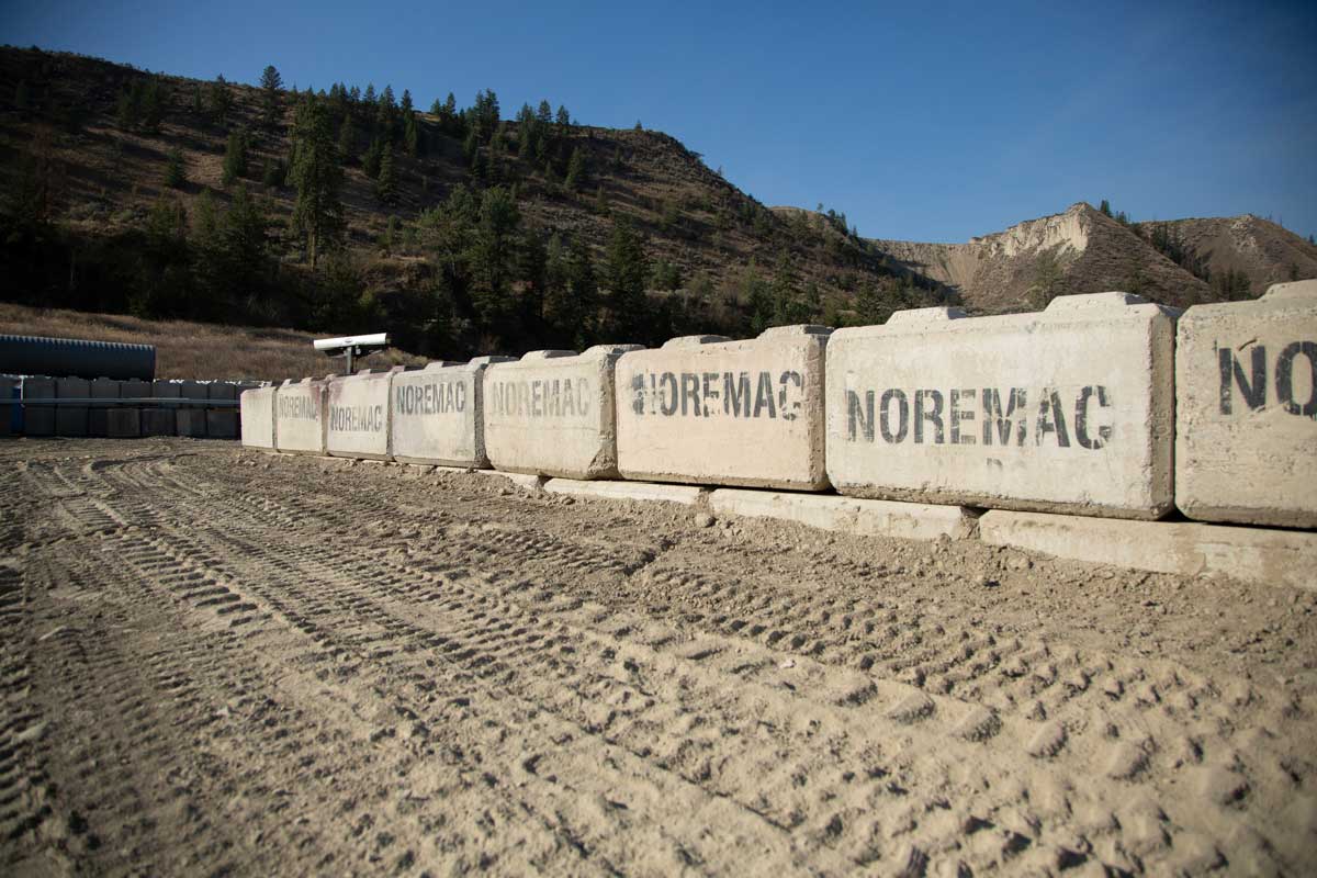 Concrete lock blocks, the Noremac logo adorning each.