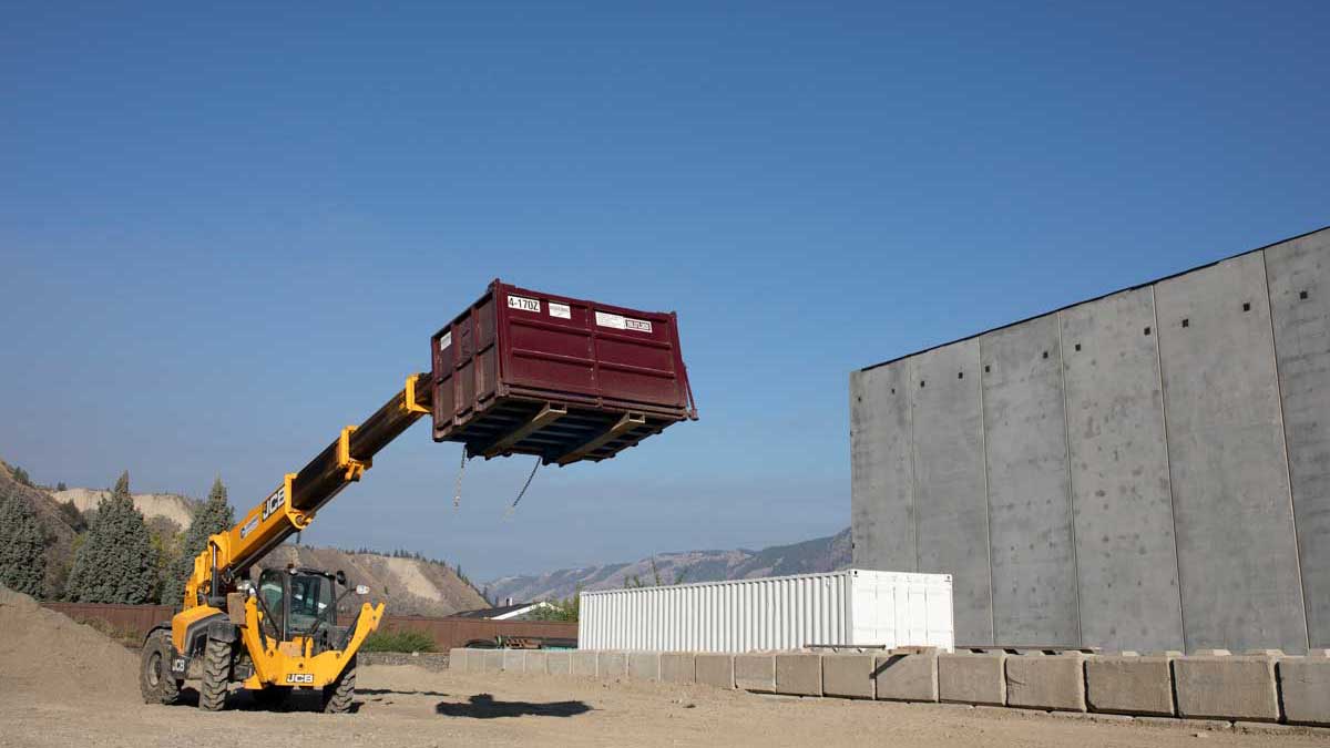 A Noremac branded zoom boom in action, blue sky in the background.