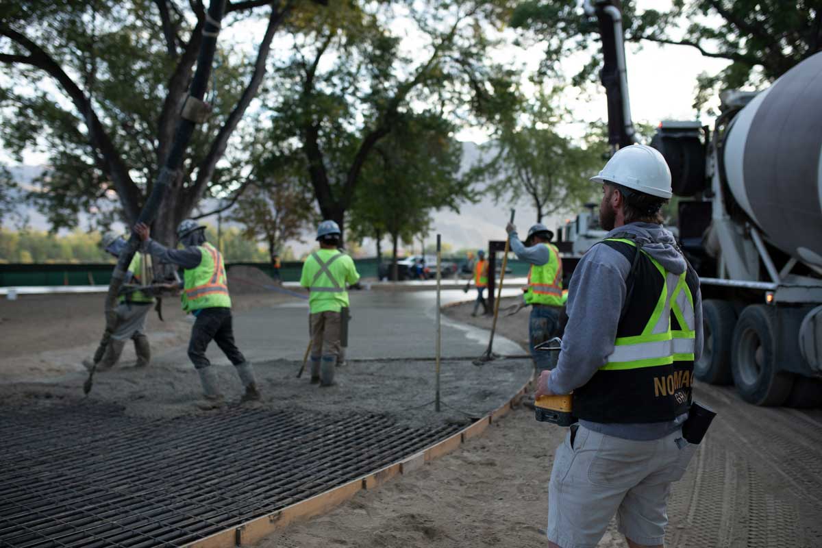 A Noremac team member proudly oversees his team pouring concrete.